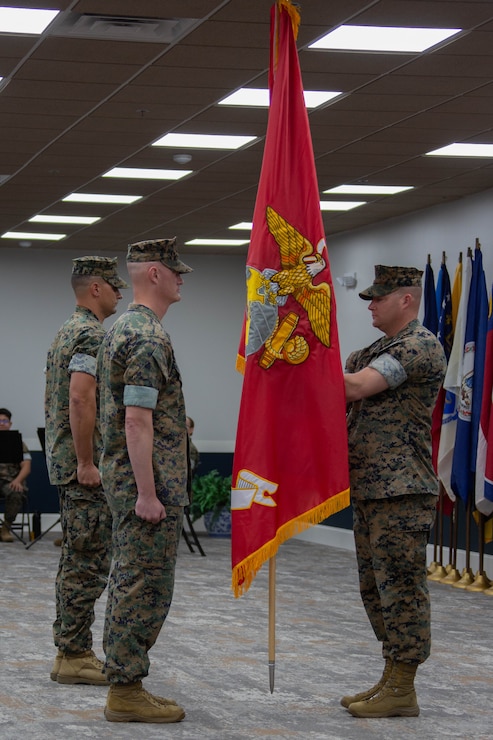 U.S. Marine Corps Sgt. Maj. Casey S. Chandler, right, passes the colors to Lt. Col. Andrew S. Walker, outgoing commanding officer, both with 2nd Network Battalion, Marine Corps Cyberspace Operations Group, during the 2nd Network Battalion change of command ceremony at Tun Alley on Marine Corps Base Camp Lejeune, North Carolina, June 13, 2025. The change of command ceremony represents the passing of responsibility, authority and accountability from the outgoing commanding officer to the incoming commanding officer. (U.S. Marine Corps photo by Lance Cpl. Hunter Brock)