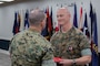 U.S. Marine Corps Col. Bryan Eovito, left, commanding officer, Marine Corps Cyberspace Operations Group, presents Lt. Col. Andrew Walker, outgoing commanding officer, 2nd Network Battalion, Marine Corps Cyberspace Operations Group, with a Meritorious Service Medal during the 2nd Network Battalion change of command ceremony at Tun Alley on Marine Corps Base Camp Lejeune, North Carolina, June 13, 2025. The change of command ceremony represents the passing of responsibility, authority and accountability from the outgoing commanding officer to the incoming commanding officer. (U.S. Marine Corps photo by Lance Cpl. Hunter Brock)