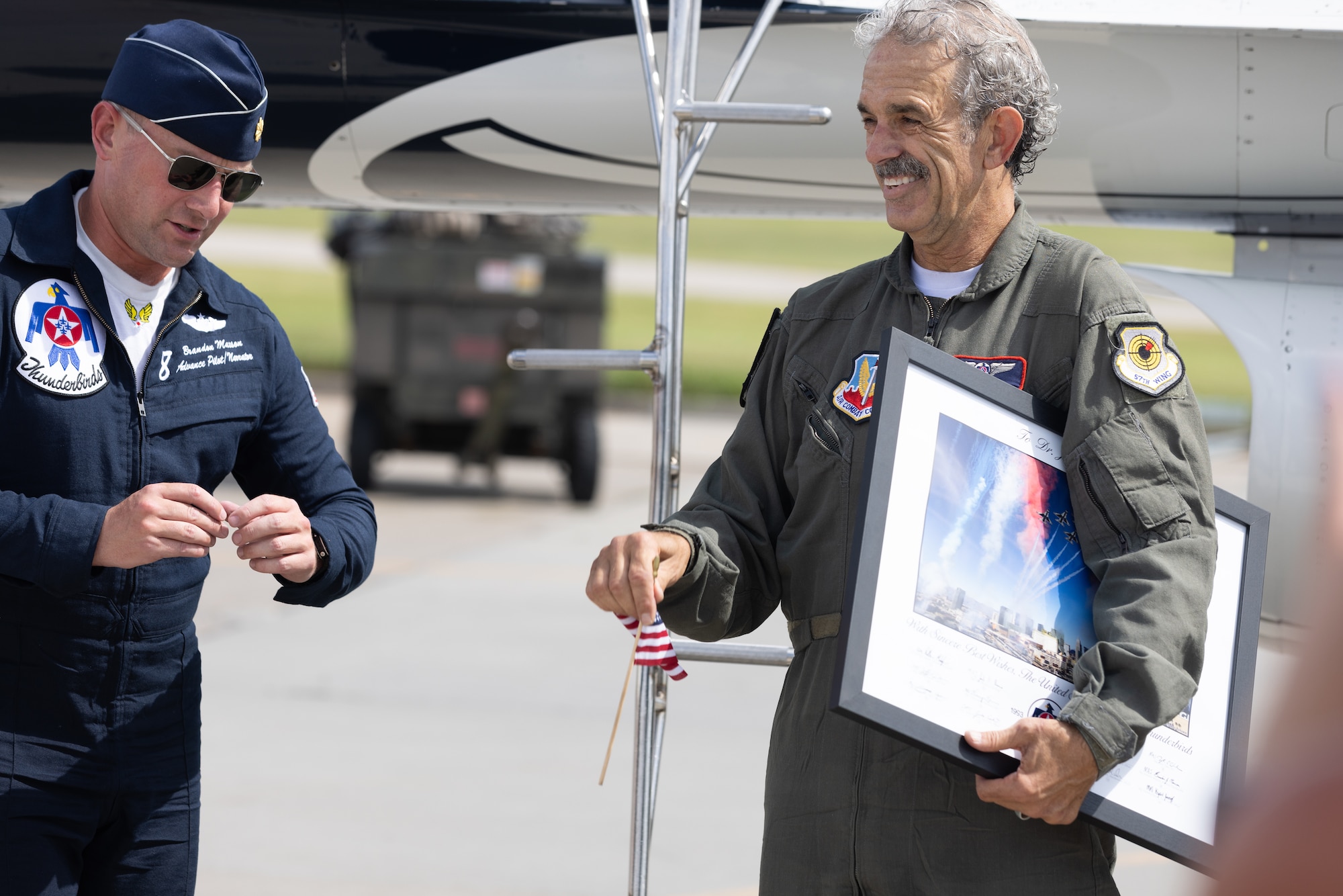 Pilot gives man a pin.