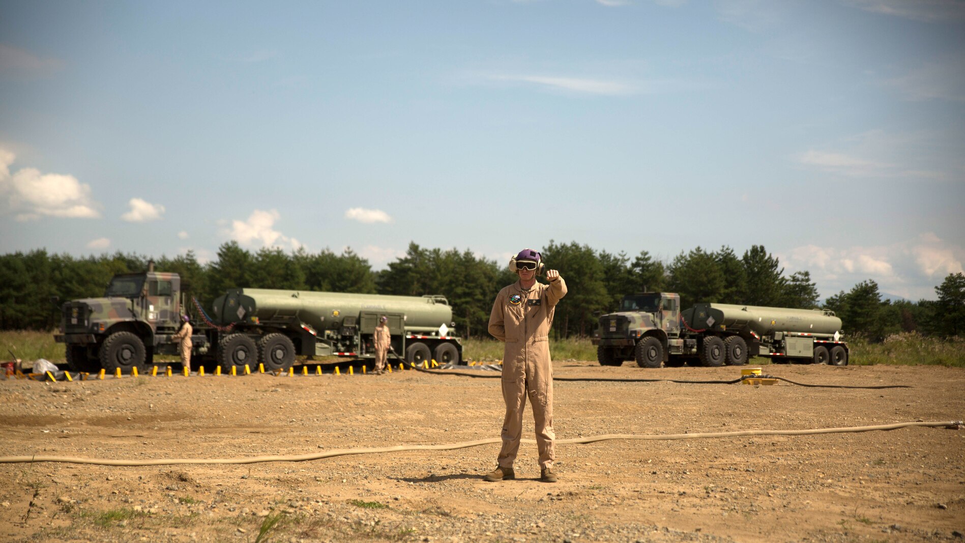 A U.S. Marine with Marine Wing Support Squadron 171 signals a Marine Heavy Helicopter Squadron 462 CH-53E Super Stallion rotary-wing aircraft to hold their position at Aibano Training Area, Sept. 15, 2015. MWSS-171 provided fuel for HMH-462 at a forward arming and refueling point during an assault transport. The assault transport supported a bilateral air assault comprehensive exercise during Forest Light 16-1. FL 16-1 is an exercise to increase interoperability of Japan Ground Self-Defense Force and U.S. Marine Corps forces. MWSS-171 is with Marine Aircraft Group 12, 1st Marine Aircraft Wing, III Marine Expeditionary Force. HMH-462 is with MAG 16, 3rd MAW, currently assigned to MAG 36, 1st MAW, III MEF. (U.S. Marine Corps photo by Lance Cpl. Mandaline Hatch/Released)