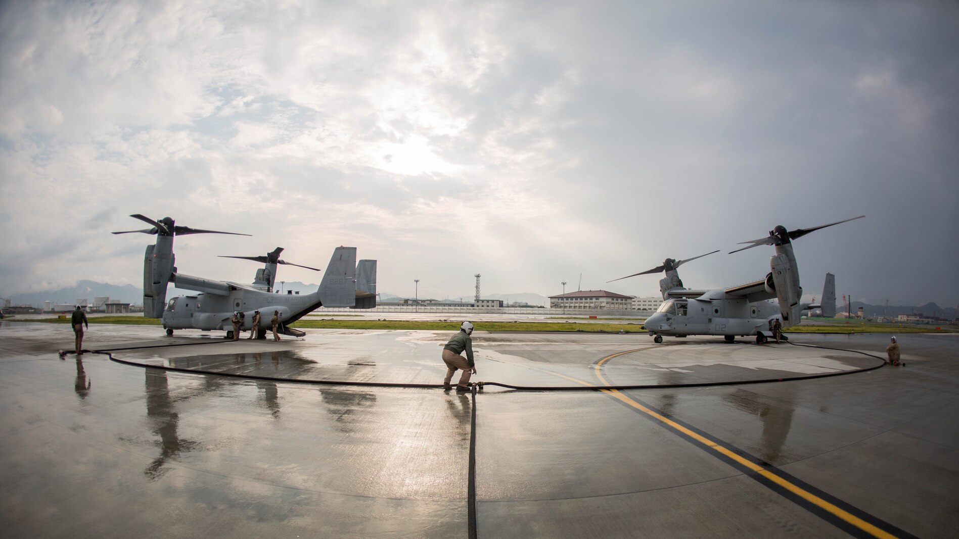 Marines with Marine Aerial Refueler Transport Squadron (VMGR) 152 MV-22B Osprey tiltrotor aircrafts with Marine Medium Tiltrotor Squadron 262 during air delivery ground refueling training aboard Marine Corps Air Station Iwakuni, Japan, Aug. 21, 2015. The KC-130J aircraft is capable of carrying more than 12,000 gallons of fuel and simultaneously refueling two aircraft at 300 gallons a minute. This ability, along with many others, makes VMGR-152 and their aircraft an important asset to Marine Corps’ aviation. (U.S. Marine Corps photo by Cpl. Carlos Cruz Jr./Released)