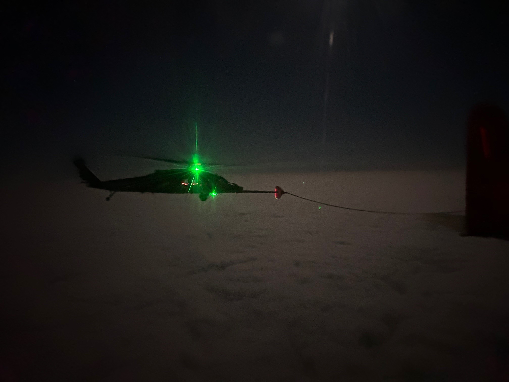 A 305th Rescue Squadron HH-60W Jolly Green II helicopter receives fuel