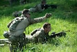 Soldiers of 3rd Platoon, Charlie Company, 1st Battalion, 149th Infantry, practice assault tactics using blank fire ammunition on a training range as a part of the Exportable Combat Training Center (XCTC) exercise at Fort Pickett, Virginia, June 19, 2025.