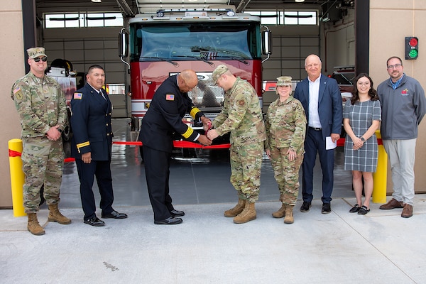 Kirtland AFB Fire Department Deputy Fire Chief Antwaun McClelland, 3rd from left, and Col Michael Power, commander, 377th Air Base Wing, cut the red ribbon and officially open Fire Station #3, June 13, 2025. USACE-Albuquerque District employees in the photo include Maj. Matthew Nulk, far left, contract specialist, and Jacob Pauley, far right, deputy district engineer.