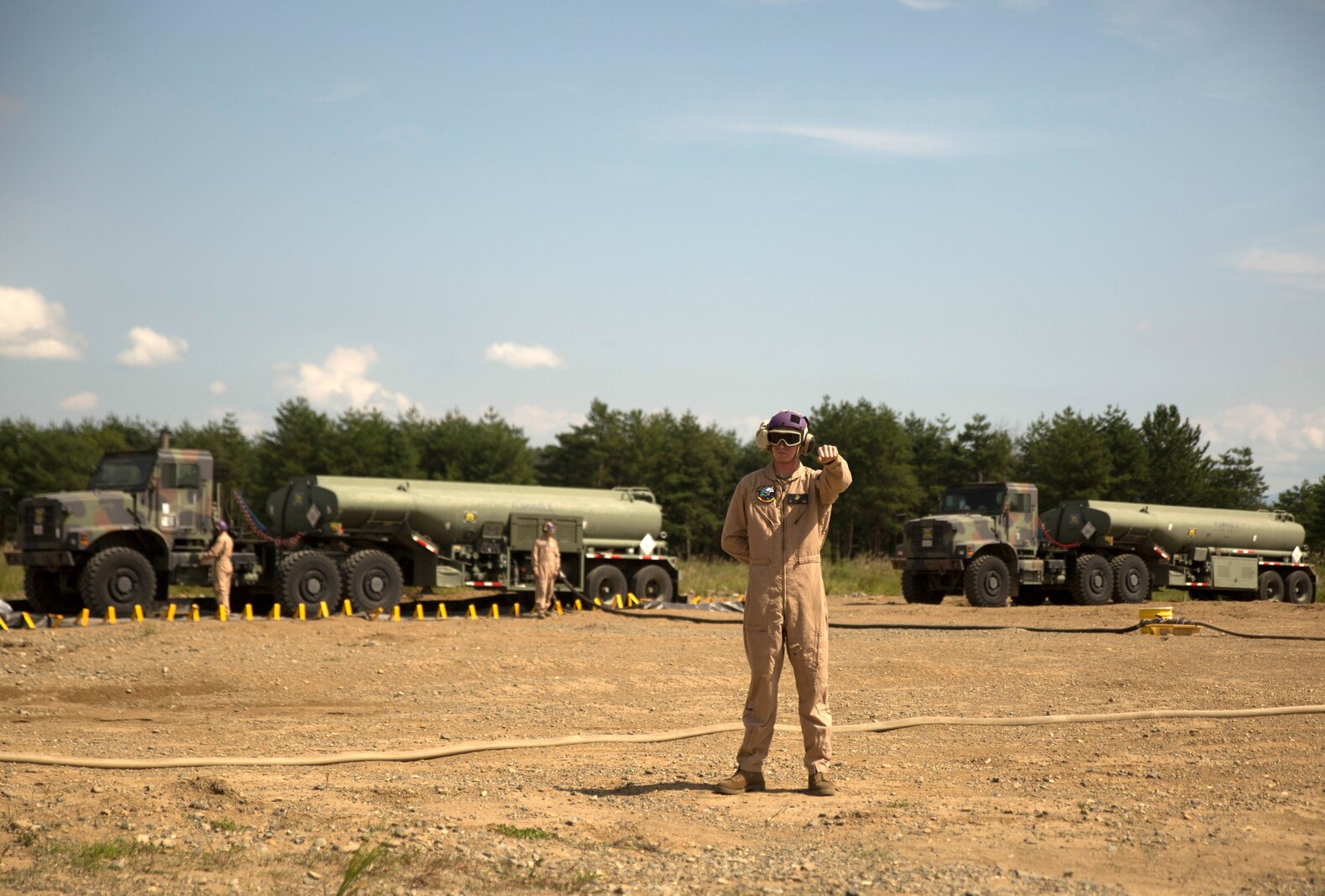 A U.S. Marine with Marine Wing Support Squadron 171 signals a Marine Heavy Helicopter Squadron 462 CH-53E Super Stallion rotary-wing aircraft to hold their position at Aibano Training Area, Sept. 15, 2015. MWSS-171 provided fuel for HMH-462 at a forward arming and refueling point during an assault transport. The assault transport supported a bilateral air assault comprehensive exercise during Forest Light 16-1. FL 16-1 is an exercise to increase interoperability of Japan Ground Self-Defense Force and U.S. Marine Corps forces. MWSS-171 is with Marine Aircraft Group 12, 1st Marine Aircraft Wing, III Marine Expeditionary Force. HMH-462 is with MAG 16, 3rd MAW, currently assigned to MAG 36, 1st MAW, III MEF.