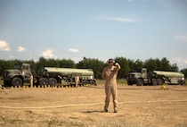 A U.S. Marine with Marine Wing Support Squadron 171 signals a Marine Heavy Helicopter Squadron 462 CH-53E Super Stallion rotary-wing aircraft to hold their position at Aibano Training Area, Sept. 15, 2015. MWSS-171 provided fuel for HMH-462 at a forward arming and refueling point during an assault transport. The assault transport supported a bilateral air assault comprehensive exercise during Forest Light 16-1. FL 16-1 is an exercise to increase interoperability of Japan Ground Self-Defense Force and U.S. Marine Corps forces. MWSS-171 is with Marine Aircraft Group 12, 1st Marine Aircraft Wing, III Marine Expeditionary Force. HMH-462 is with MAG 16, 3rd MAW, currently assigned to MAG 36, 1st MAW, III MEF.