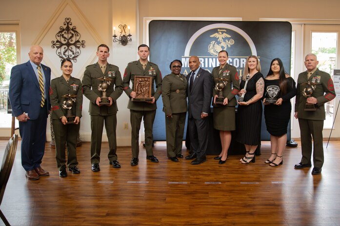 Awardees poses with Wounded Warrior Regiment staff and external partners during a ceremony near Marine Corps Base Quantico, Va., May 03, 2024. Awardees were recognized for their superior performance while facilitating the recover of wounded, ill and injured members. (U.S. Marine Corps photo by Cpl. Enos Jimenez)