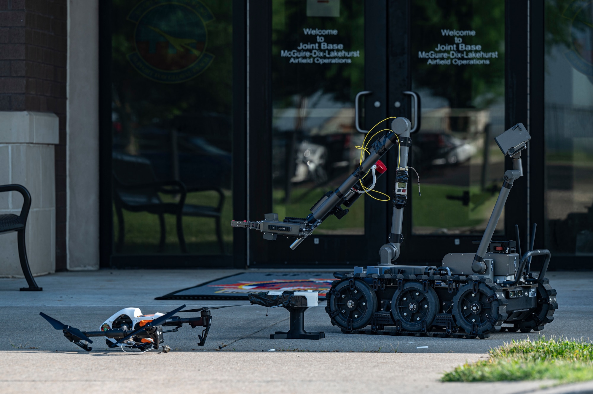 A robot operated by 87th Civil Engineer Squadron Explosive Ordinance Disposal (EOD) technicians to inspect a drone during exercise Jersey Dawn 25 at Joint Base McGuire-Dix-Lakehurst, N.J., June 29, 2025.