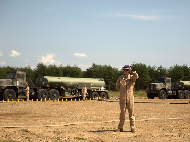 A U.S. Marine with Marine Wing Support Squadron 171 signals a Marine Heavy Helicopter Squadron 462 CH-53E Super Stallion rotary-wing aircraft to hold their position at Aibano Training Area, Sept. 15, 2015. MWSS-171 provided fuel for HMH-462 at a forward arming and refueling point during an assault transport. The assault transport supported a bilateral air assault comprehensive exercise during Forest Light 16-1. FL 16-1 is an exercise to increase interoperability of Japan Ground Self-Defense Force and U.S. Marine Corps forces. MWSS-171 is with Marine Aircraft Group 12, 1st Marine Aircraft Wing, III Marine Expeditionary Force. HMH-462 is with MAG 16, 3rd MAW, currently assigned to MAG 36, 1st MAW, III MEF.