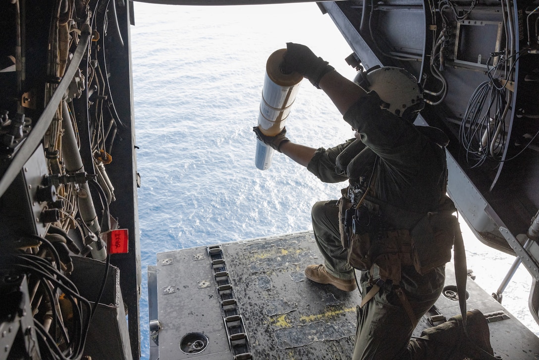 U.S. Marine Corps Sgt. Victor Estes, from Alabama, an MV-22B Osprey crew chief with Marine Medium Tiltrotor Squadron (VMM) 162, drops sonobuoys out of an MV-22B Osprey during a flight near Surface Combat Systems Center Wallops Island, Virginia, July 2, 2025. Atlantic Alliance 2025 (AA25) is the premier East Coast naval integration exercise, featuring over 25 U.S. Navy and Marine Corps units alongside Dutch naval forces and British Royal Commandos. Spanning from North Carolina to Maine, AA25 will showcase a range of dynamic events including force integration, air assault operations, bilateral reconnaissance, naval strait transits, amphibious assault training, and a simulated war-at-sea exercise. (U.S. Marine Corps photo by Lance Cpl. Orlanys Diaz Figueroa)