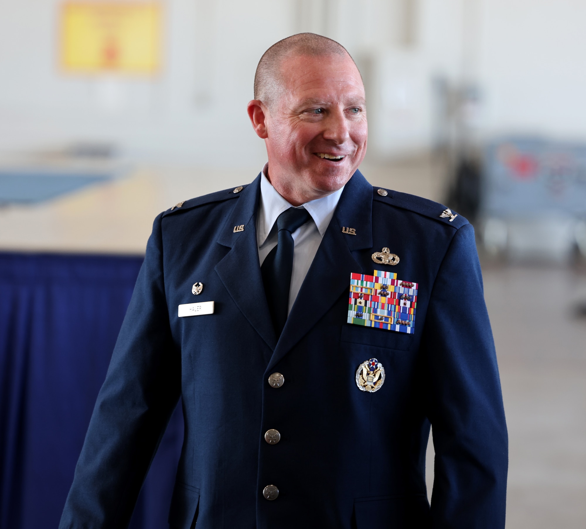 Col. Eric Haler exits the stage after relinquishing command to Col. Andrew Adams