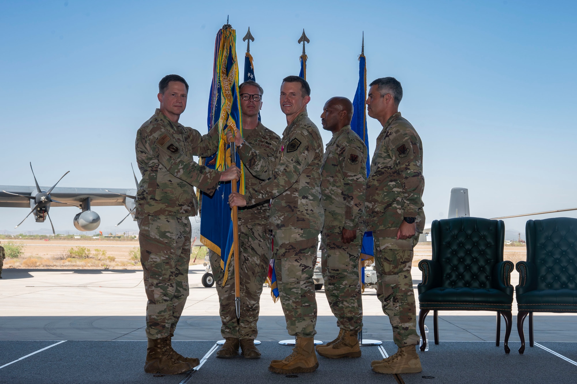 U.S. Air Force Maj. General David Lyons, 15th Air Force commander, takes the guidon from Col. Scott Mills, outgoing 355th Wing commander, during the 355th Wing Change of Command ceremony at Davis-Monthan Air Force Base, Arizona, July 10, 2025. The ceremony marked a formal transition of leadership as Mills concluded his command and Col. Jose Cabrera assumed responsibility for the wing. (U.S. Air Force photo by Airman Samantha Melecio)