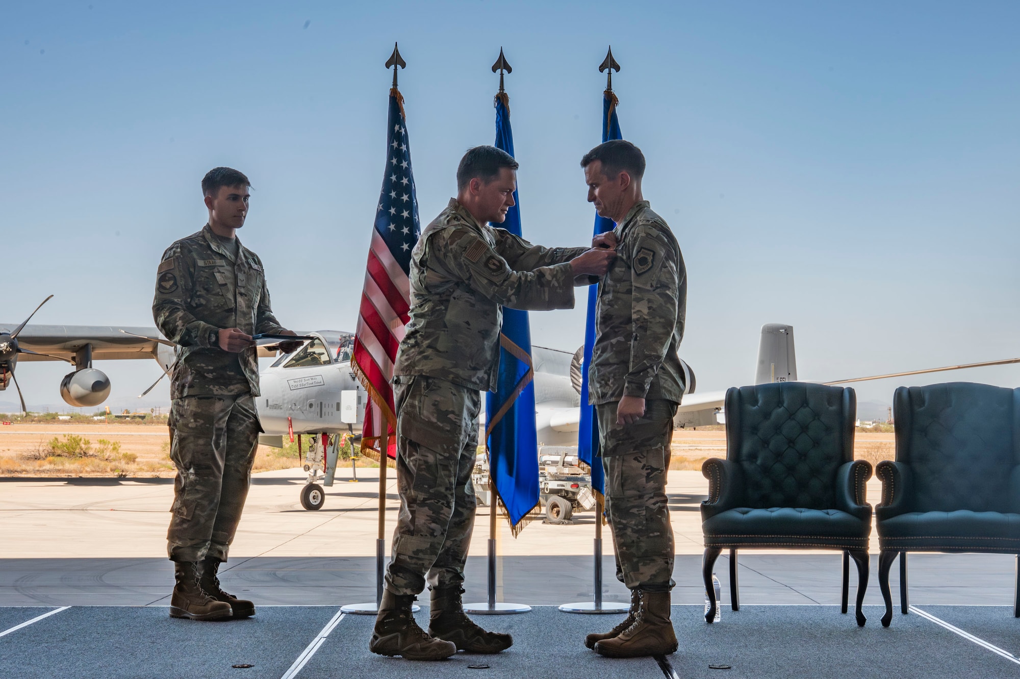 U.S. Air Force Maj. General David Lyons, 15th Air Force commander, pins the Legion of Merit medal on Col. Scott Mills, outgoing 355th Wing commander, during the 355th Wing Change of Command ceremony at Davis-Monthan Air Force Base, Arizona, July 20, 2025. During his tenure, Mills led the wing through key mission advancements and strengthened its warfighting capabilities. (U.S. Air Force photo by Airman Samantha Melecio)