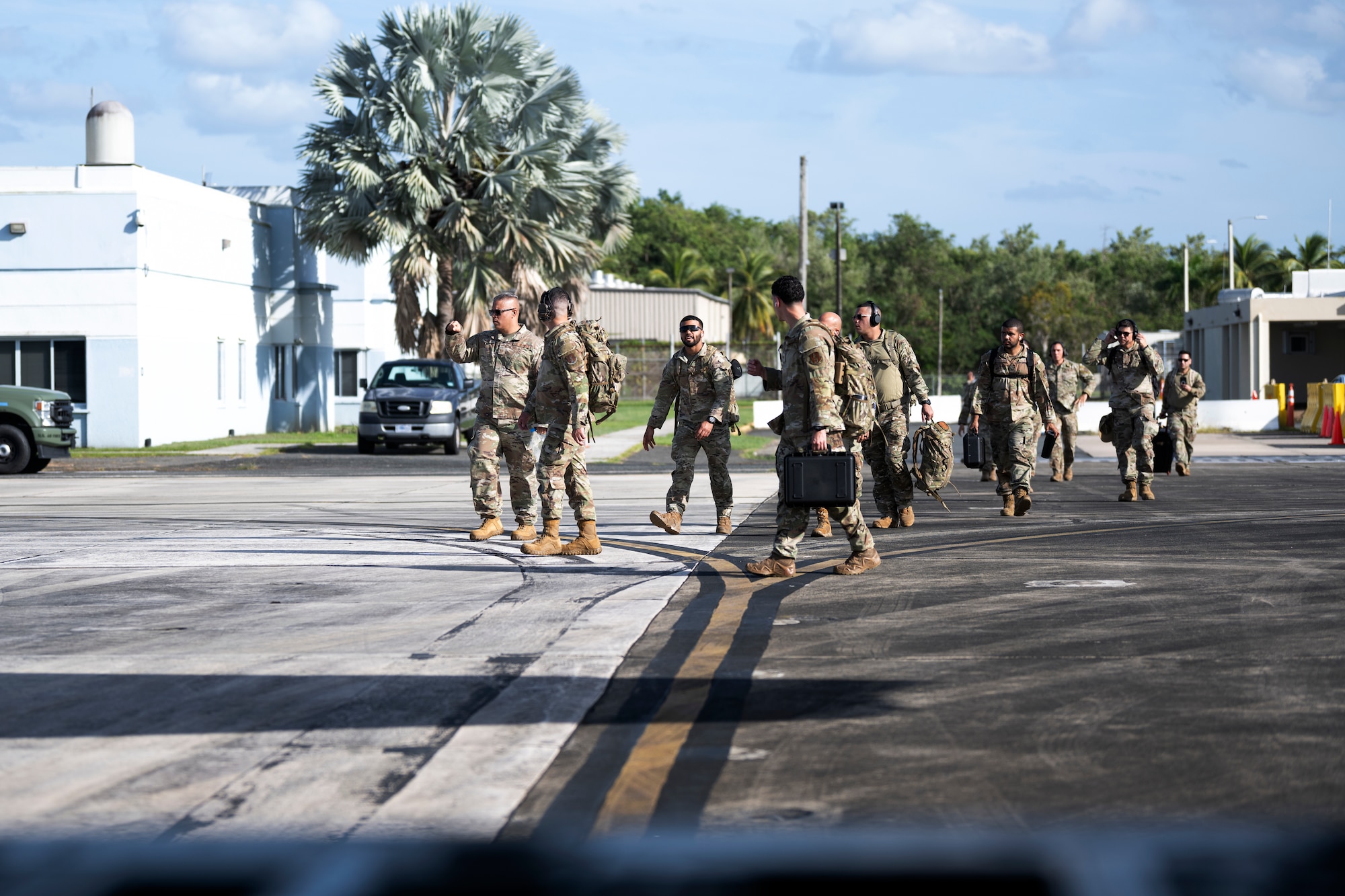 Group of Airmen walk on the flightline
