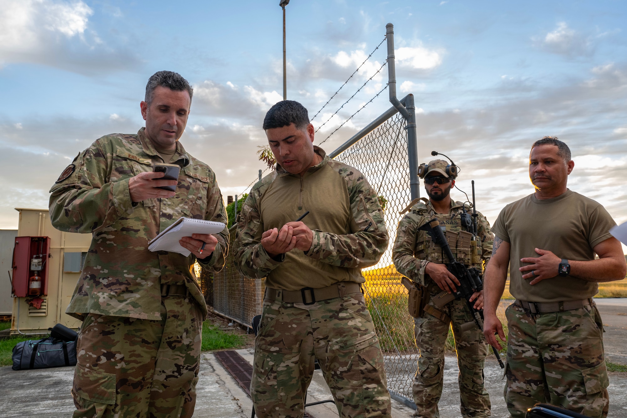 4 Airmen from Virginia and Puerto Rico ANG stand talking together