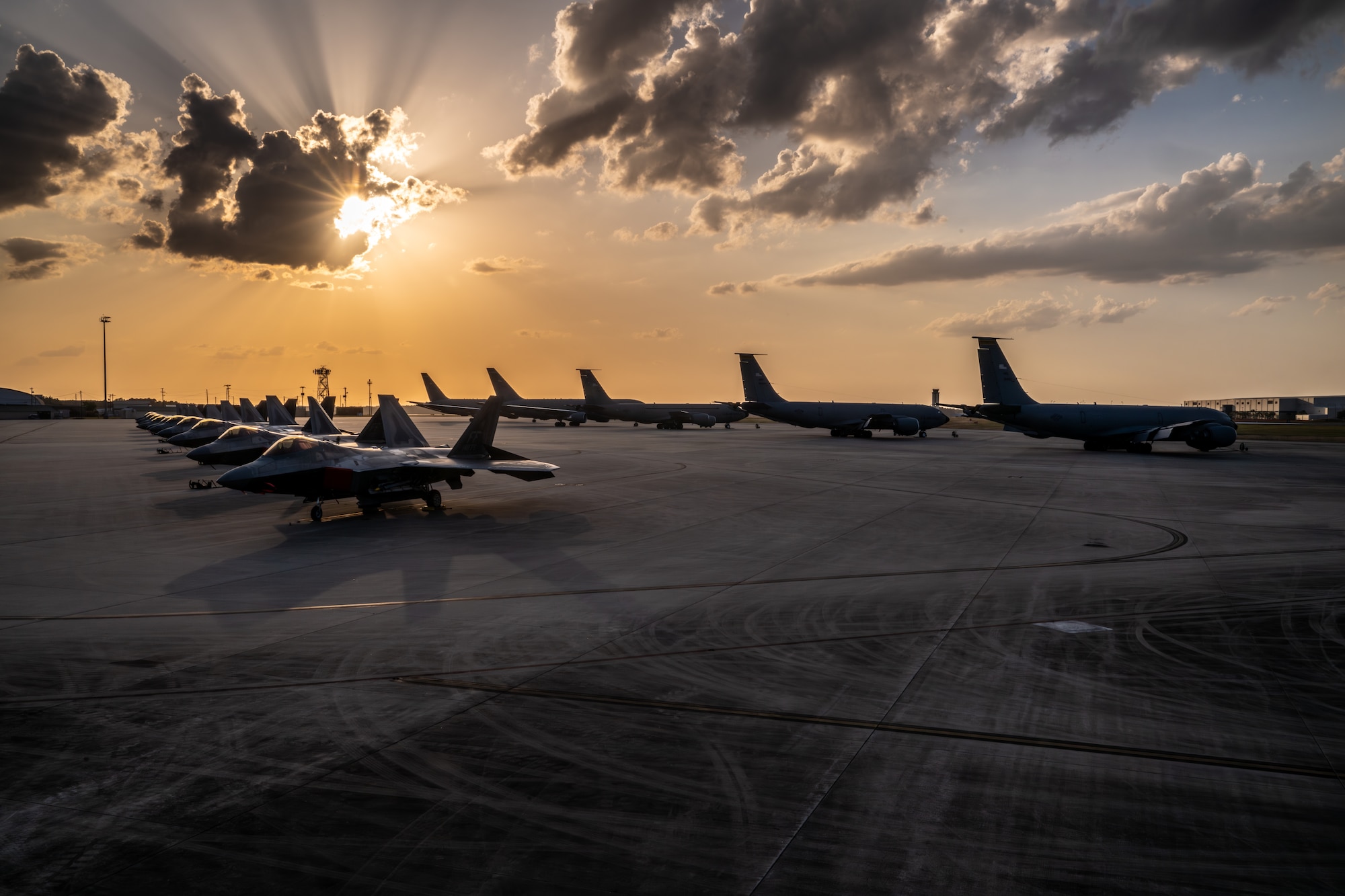 U.S. Air Force aircraft including F-22 Raptors, KC-135R Stratotankers, KC-46A Pegasus and C-130 Hercules are parked on the flightline at Savannah Air National Guard Base, Georgia.
