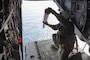 U.S. Marine Corps Sgt. Victor Estes, from Alabama, an MV-22B Osprey crew chief with Marine Medium Tiltrotor Squadron (VMM) 162, drops sonobuoys out of an MV-22B Osprey during a flight near Surface Combat Systems Center Wallops Island, Virginia, July 2, 2025. Atlantic Alliance 2025 (AA25) is the premier East Coast naval integration exercise, featuring over 25 U.S. Navy and Marine Corps units alongside Dutch naval forces and British Royal Commandos. Spanning from North Carolina to Maine, AA25 will showcase a range of dynamic events including force integration, air assault operations, bilateral reconnaissance, naval strait transits, amphibious assault training, and a simulated war-at-sea exercise. (U.S. Marine Corps photo by Lance Cpl. Orlanys Diaz Figueroa)