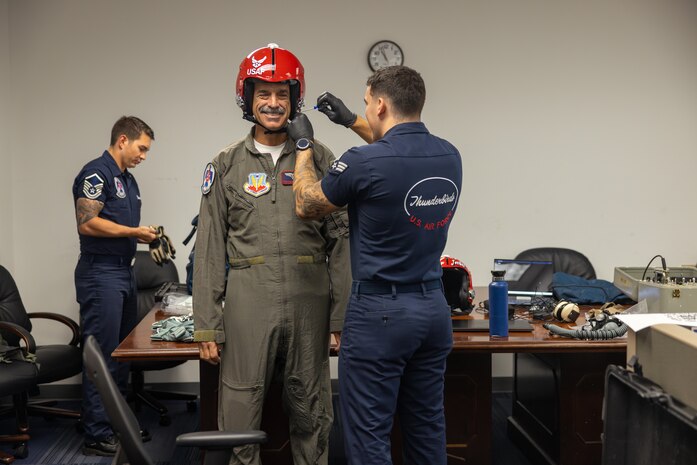 Three men preparing for flight.
