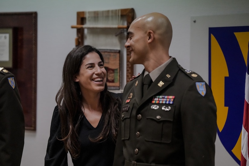Newly promoted Maj. Alec Velasco enjoys the moment with his wife, Stella, at his promotion ceremony in December of 2023. Velasco is now the executive officer for Army Field Support Battalion-Germany, and Stella is a staff employee at the Netzaberg Youth Center in Grafenwoehr, Germany, where they live. (U.S. Army courtesy photo)
