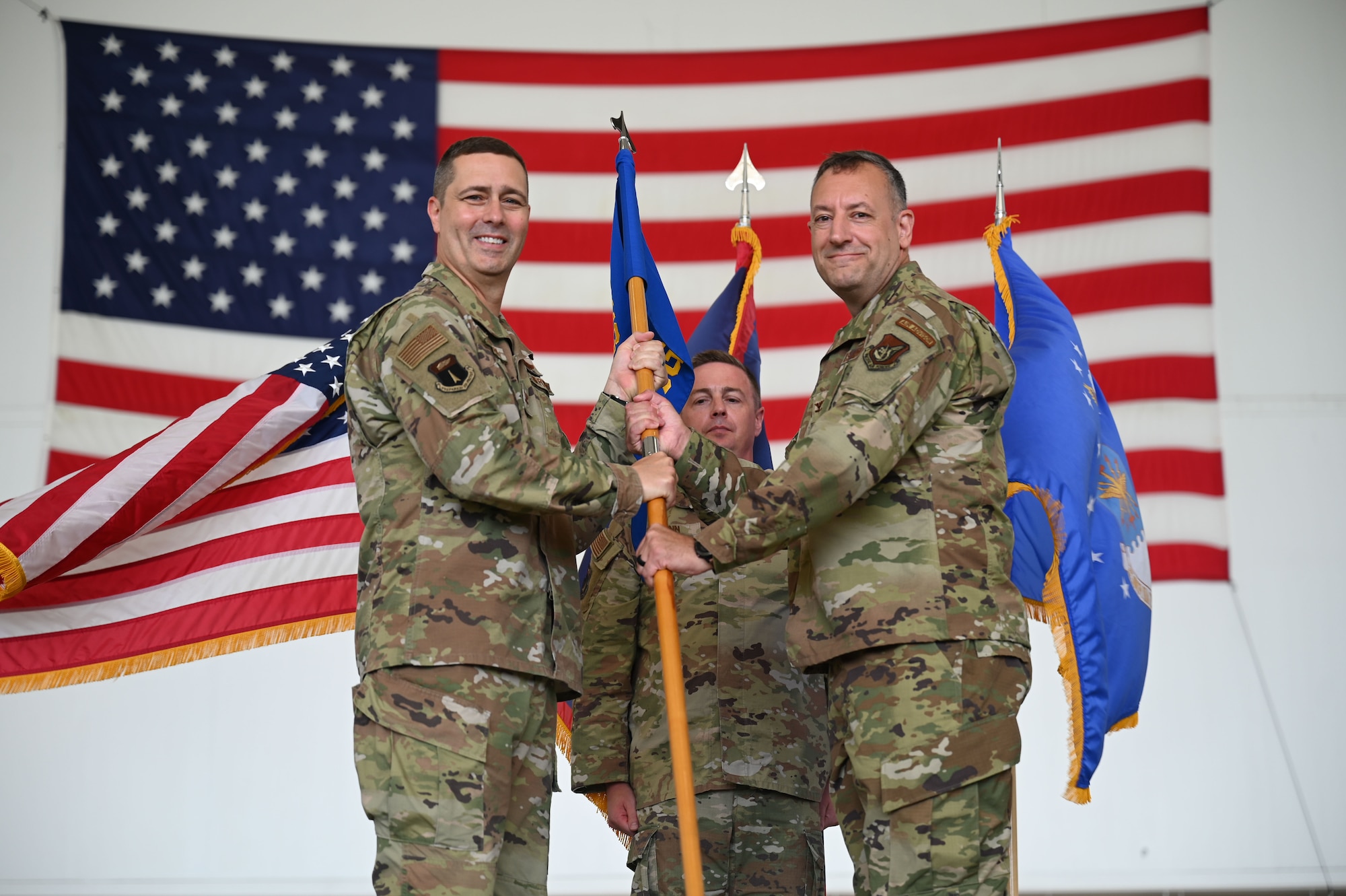 Photo of a commander passing a guidon during a change of command ceremony