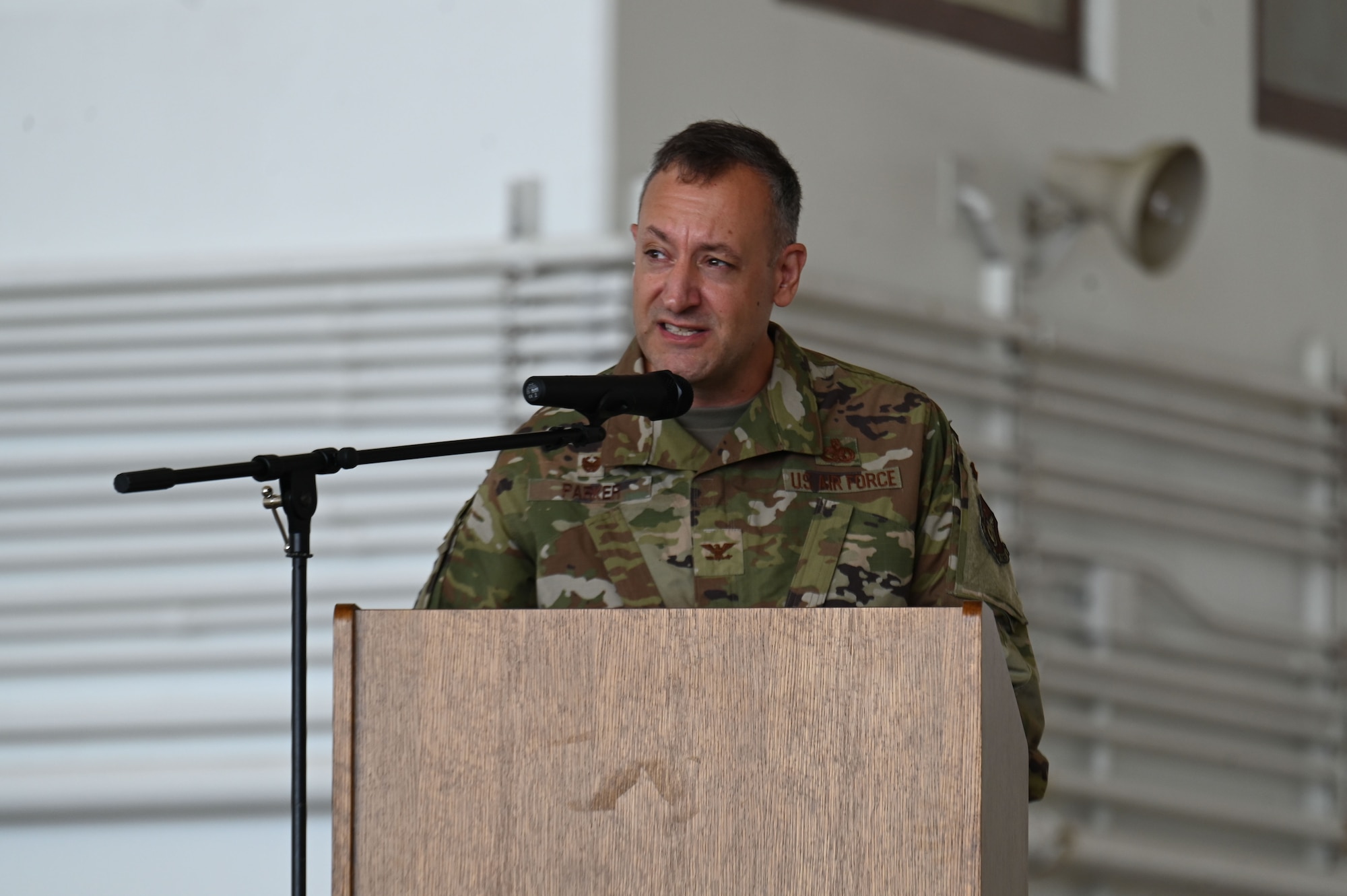 Photo of a commander giving remarks during a change of command ceremony