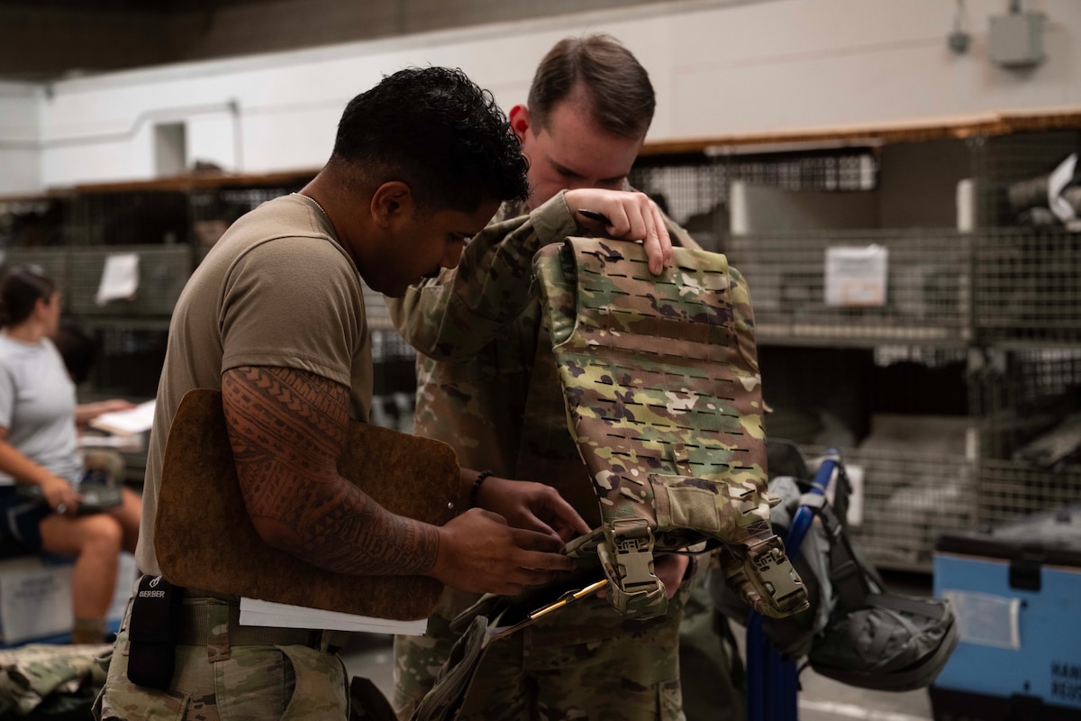 U.S. Air Force Senior Airman Daniel Pescheck and Airman 1st Class Swinton Jack, Individual Protection Equipment (IPE) journeymen with the 39th Logistics Readiness Squadron, prepare gear at Incirlik Air Base, Türkiye, July 3, 2025. The IPE team equips Airmen for both exercises and real-world contingencies, supporting an average of 100 to 120 incoming personnel each month. (U.S. Air Force photo by Senior Airman Greydon Furstenau)