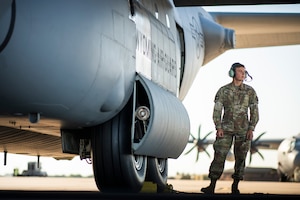 Airman standing next to C-130