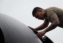 U.S. Air Force Staff Sgt. Peter James Olandez, 23rd Expeditionary Bomber Generation Squadron dedicated crew chief, performs post-flight maintenance on a B-52H Stratofortress after a Bomber Task Force mission at Andersen Air Force Base, Guam, July 7, 2025. The BTF missions enhance operational readiness and provide the training necessary to respond to any potential crisis or challenge in the Indo-Pacific. (U.S. Air Force photo by Senior Airman Alyssa Bankston)