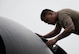 U.S. Air Force Staff Sgt. Peter James Olandez, 23rd Expeditionary Bomber Generation Squadron dedicated crew chief, performs post-flight maintenance on a B-52H Stratofortress after a Bomber Task Force mission at Andersen Air Force Base, Guam, July 7, 2025. The BTF missions enhance operational readiness and provide the training necessary to respond to any potential crisis or challenge in the Indo-Pacific. (U.S. Air Force photo by Senior Airman Alyssa Bankston)