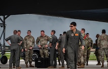 U.S. Air Force Airmen assigned to the 5th Bomb Wing, Minot Air Force Base, North Dakota, greet new arrivals supporting a Bomber Task Force mission at Andersen Air Force Base, Guam, July 7, 2025. These missions deter adversaries, assure allies and partners, strengthen interoperability, and maintain readiness and global strike capability. (U.S. Air Force photo by Senior Airman Alyssa Bankston)