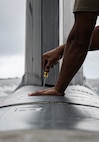 U.S. Air Force Staff Sgt. Jovan Marrero, 23rd Expeditionary Bomber Generation Squadron crew chief, performs post-flight maintenance on a USAF B-52H Stratofortress after a Bomber Task Force mission at Andersen Air Force Base, Guam, July 7, 2025. The BTF missions enable crews to maintain a high state of readiness, proficiency, and validate the always-ready global strike capability. (U.S. Air Force photo by Senior Airman Alyssa Bankston)