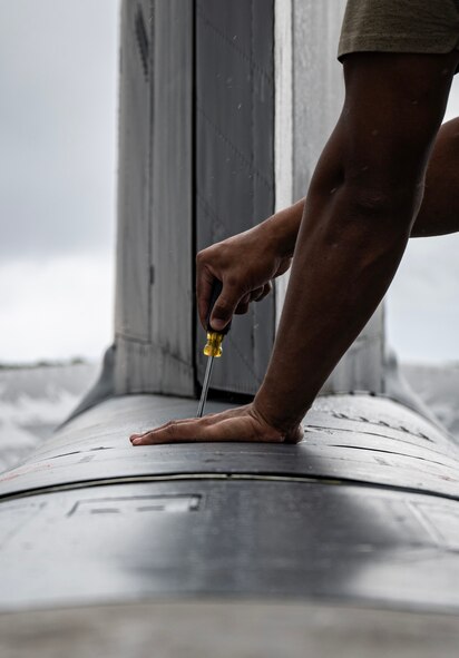 U.S. Air Force Staff Sgt. Jovan Marrero, 23rd Expeditionary Bomber Generation Squadron crew chief, performs post-flight maintenance on a USAF B-52H Stratofortress after a Bomber Task Force mission at Andersen Air Force Base, Guam, July 7, 2025. The BTF missions enable crews to maintain a high state of readiness, proficiency, and validate the always-ready global strike capability. (U.S. Air Force photo by Senior Airman Alyssa Bankston)