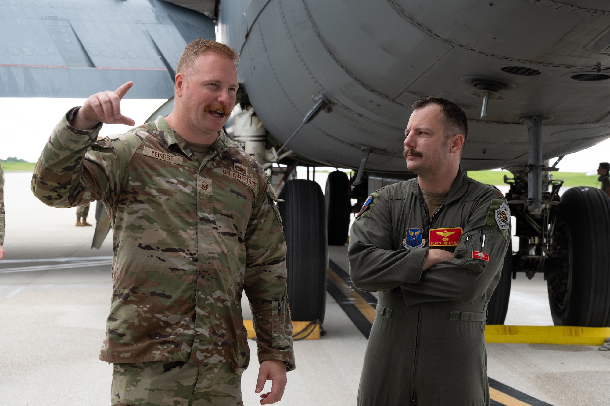 U.S. Air Force Master Sgt. Andrew Yeingst, 23rd Expeditionary Bomber Generation Squadron production superintendent (left), and USAF Maj. Noah Spitler, 23rd Expeditionary Bomb Squadron director of operations (right), conduct an informal post-flight debrief after a Bomber Task Force mission at Andersen Air Force Base, Guam, July 7, 2025. The BTF missions enable crews to maintain a high state of readiness, proficiency, and validate our always-ready global strike capability. (U.S. Air Force photo by Airman 1st Class Vincent Padilla)