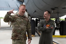 U.S. Air Force Master Sgt. Andrew Yeingst, 23rd Expeditionary Bomber Generation Squadron production superintendent (left), and USAF Maj. Noah Spitler, 23rd Expeditionary Bomb Squadron director of operations (right), conduct an informal post-flight debrief after a Bomber Task Force mission at Andersen Air Force Base, Guam, July 7, 2025. The BTF missions enable crews to maintain a high state of readiness, proficiency, and validate our always-ready global strike capability. (U.S. Air Force photo by Airman 1st Class Vincent Padilla)