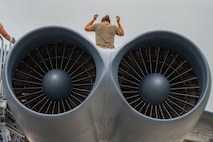 U.S. Air Force Senior Airman Bethany Jones, 23rd Expeditionary Bomber Generation Squadron assistant dedicated crew chief, performs post-flight maintenance on a USAF B-52H Stratofortress after a Bomber Task Force mission at Andersen Air Force Base, Guam, July 7, 2025. The U.S. demonstrates commitment to allies and partners, including those in the Indo-Pacific, through the global employment of military forces, such as regular BTF deployments. (U.S. Air Force photo by Airman 1st Class Vincent Padilla)