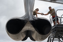 U.S. Air Force Senior Airman Bethany Jones (left), and USAF Staff Sgt. Peter James Olandez (right), 23rd Expeditionary Bomber Generation Squadron crew chiefs, perform post-flight maintenance on a USAF B-52H Stratofortress after a Bomber Task Force mission at Andersen Air Force Base, Guam, July 7, 2025. The U.S. demonstrates commitment to allies and partners, including those in the Indo-Pacific, through the global employment of military forces, such as regular BTF deployments. (U.S. Air Force photo by Airman 1st Class Vincent Padilla)