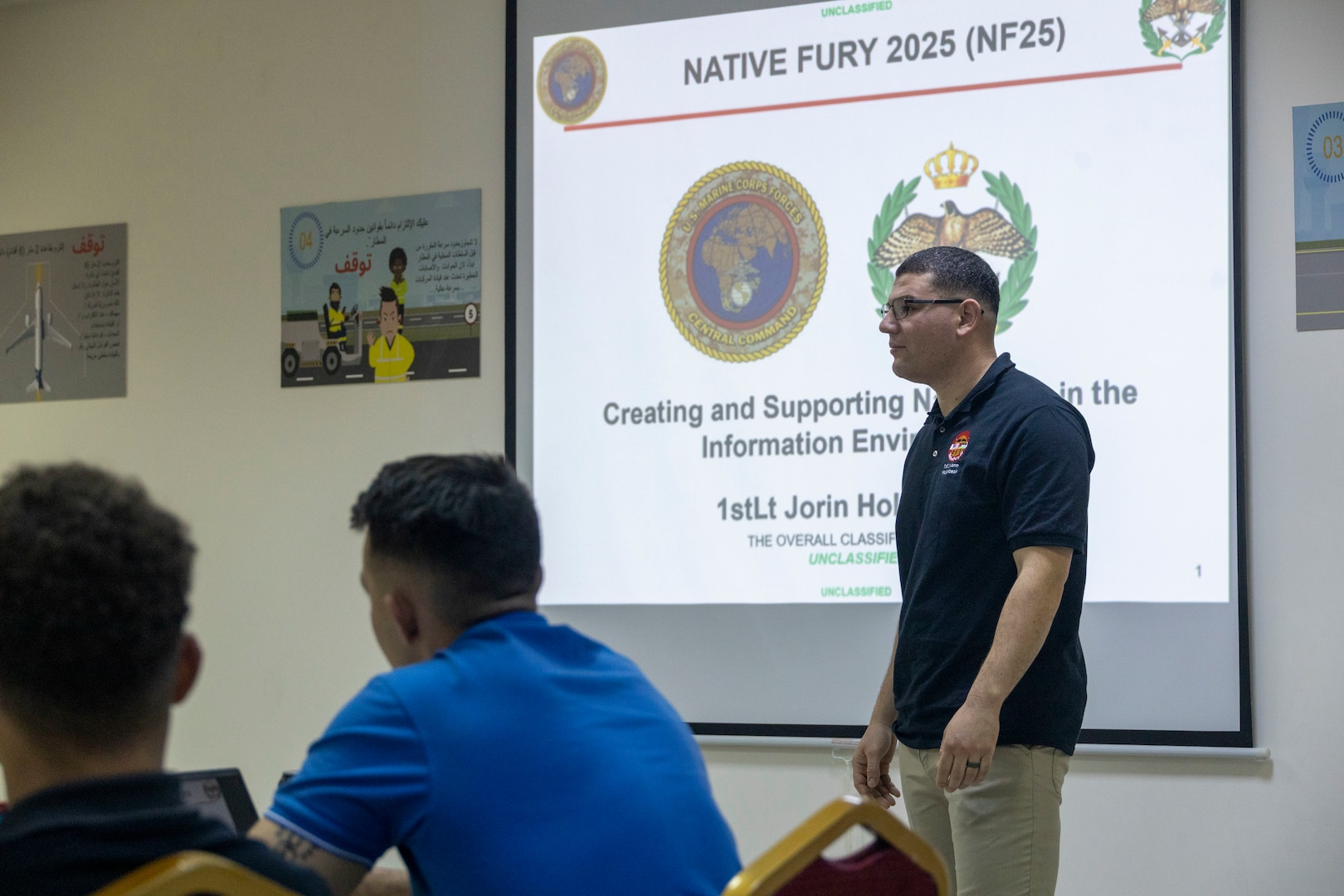 U.S. Marine Corps 1st Lt. Jorin Hollenbeak, a communications strategy and operations officer with 2nd Marine Logistics Group, teaches a class during a subject matter expert exchange with members of the Jordanian Armed Forces Directorate of Military Media as part of exercise Native Fury 25 in Jordan, June 29, 2025. Native Fury 25 is a biannual exercise focused on the demonstration of the rapid offload and integration of a Maritime Prepositioned Force in the U.S. Central Command area of responsibility in support of regional security, crisis response, and contingency operations. (U.S. Marine Corps photo by Lance Cpl. Isabella Ramos)