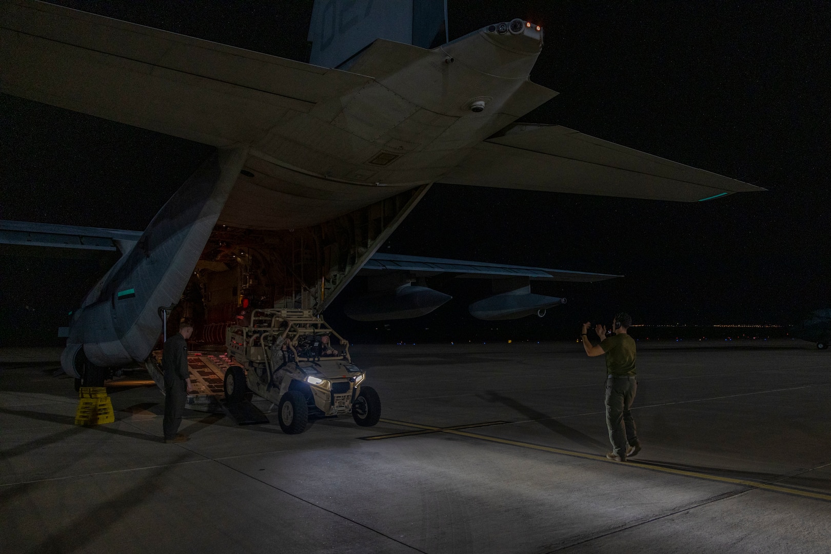 A U.S. Marine with Marine Aerial Refueler Transport Squadron (VMGR) 252, Marine Aircraft Group 14, 2nd Marine Aircraft Wing, directs a Light-Marine Air Defense Integrated System (L-MADIS) off of a KC-130J Hercules assigned to VMGR-252 upon arrival to Aqaba, Jordan, for exercise Native Fury 25, June 26, 2025. Native Fury 25 is a biannual exercise focused on the demonstration of the rapid offload and integration of a Maritime Prepositioned Force in the U.S. Central Command area of responsibility in support of regional security, crisis response, and contingency operations. (U.S. Marine Corps photo by Lance Cpl. Isabella Ramos)