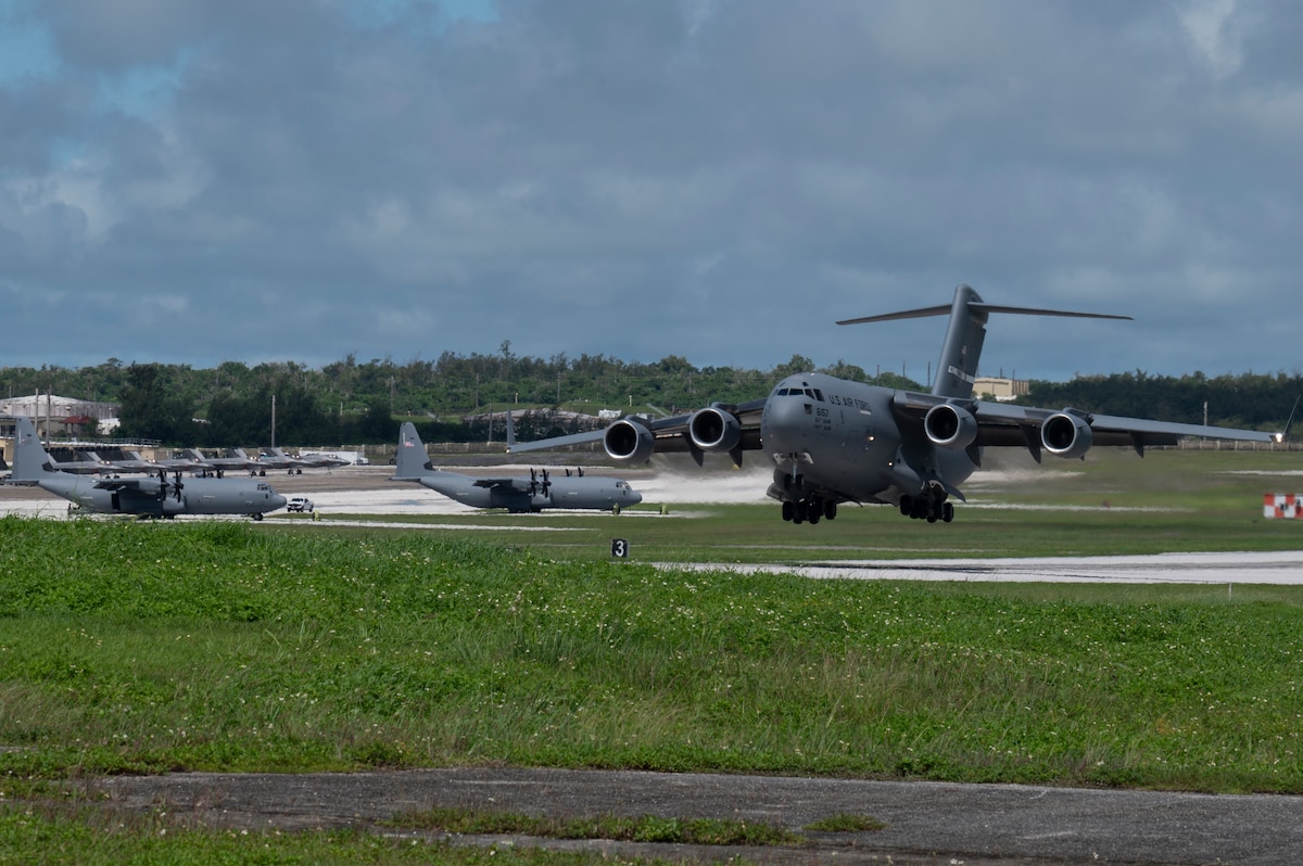 A C-17 Globemaster III assigned to the 60th Air Mobility Wing arrives at Andersen Air Force Base, Guam, in support of the Air Force’s Department-Level Exercise 2025, July 10, 2025. Air Mobility Command’s rapid deployment into theater provides the global mobility required to enable the U.S. Air Force’s execution of the DLE series at speed and scale. The DLE encompasses all branches of the Department of Defense, allies and partners, employing over 400 joint and coalition aircraft and more than 12,000 personnel across more than 50 locations spanning 3,000 miles. (U.S. Air Force photo by Staff Sgt. Dalton Williams)