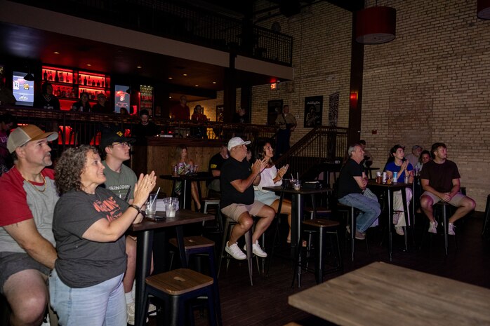 U.S. Marines and civilians applaud the Quantico Marine Rock Band at Rookies RocHaus in West Dundee, Illinois, as part of Marine Week Chicago, July 10, 2025. Throughout the year, Marines across the globe will celebrate the 250th birthday of the Corps, commemorating service, sacrifice, and priding themselves on living ‘Semper Fidelis’ or ‘Always Faithful’ to their nation and to each other. (U.S. Marine Corps photo by Lance Cpl. Elijua Guel)