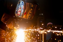 Airman using a plasma cutter