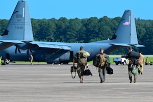 People walk on flightline.