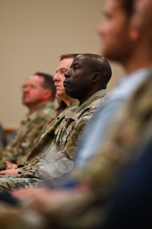 U.S. Air Force Col. Adele Ekundayo, 628th Mission Support Group commander, listens to Retired Chief Master Sgt. of the Air Force James A. Roy speak during the Professional Development Center grand opening at Joint Base Charleston.