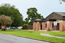 A ‘Grand Opening’ sign is placed above the entrance of the Professional Development Center building during the PDC grand opening at Joint Base Charleston.