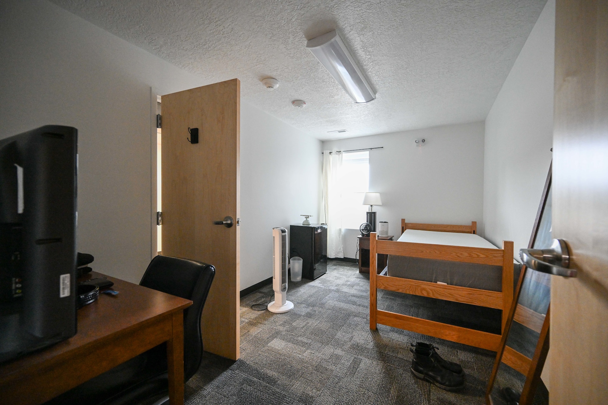 dorm room with twin bed and desk