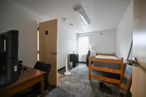dorm room with twin bed and desk