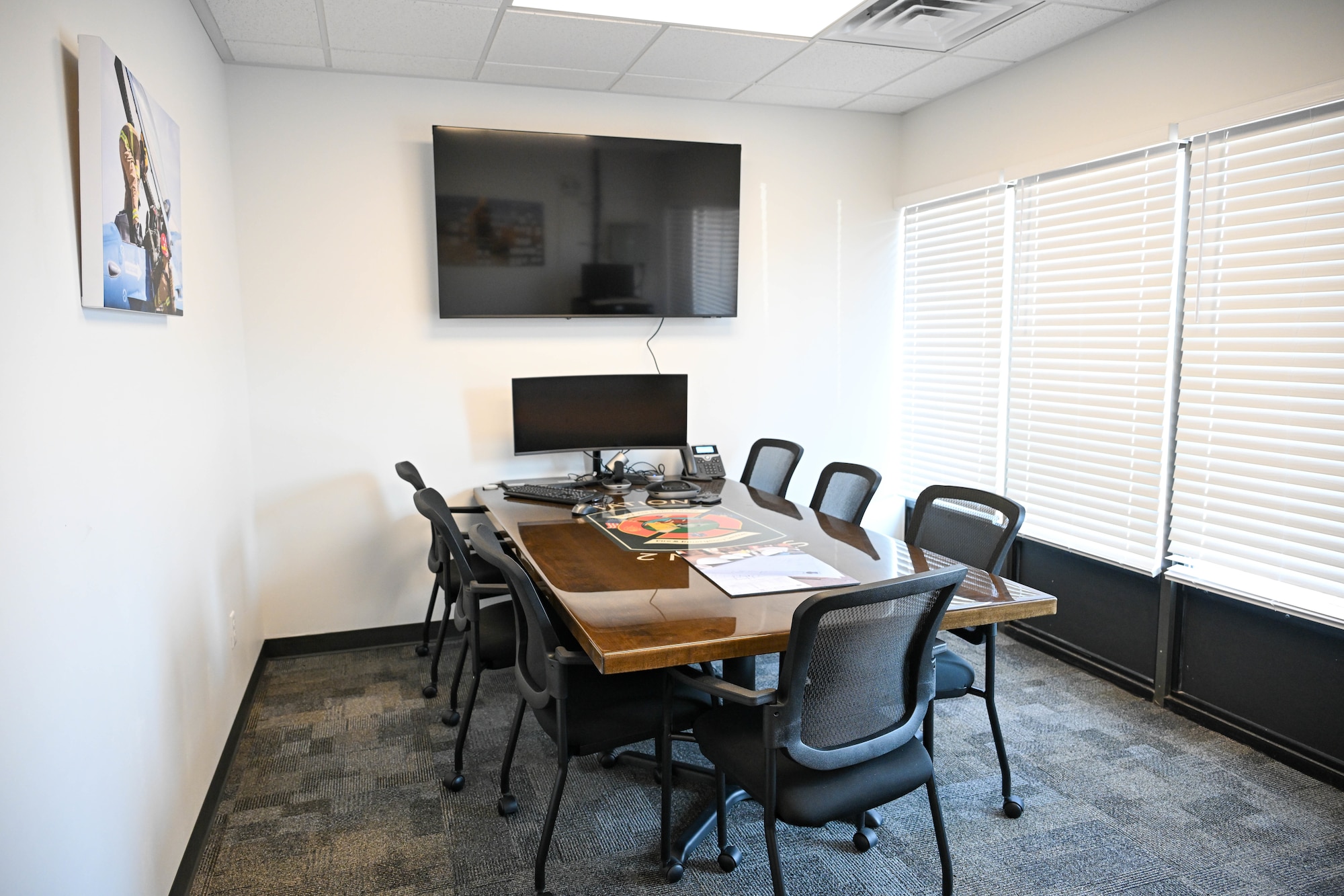 conference room with table and chairs and tv