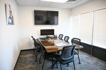 conference room with table and chairs and tv