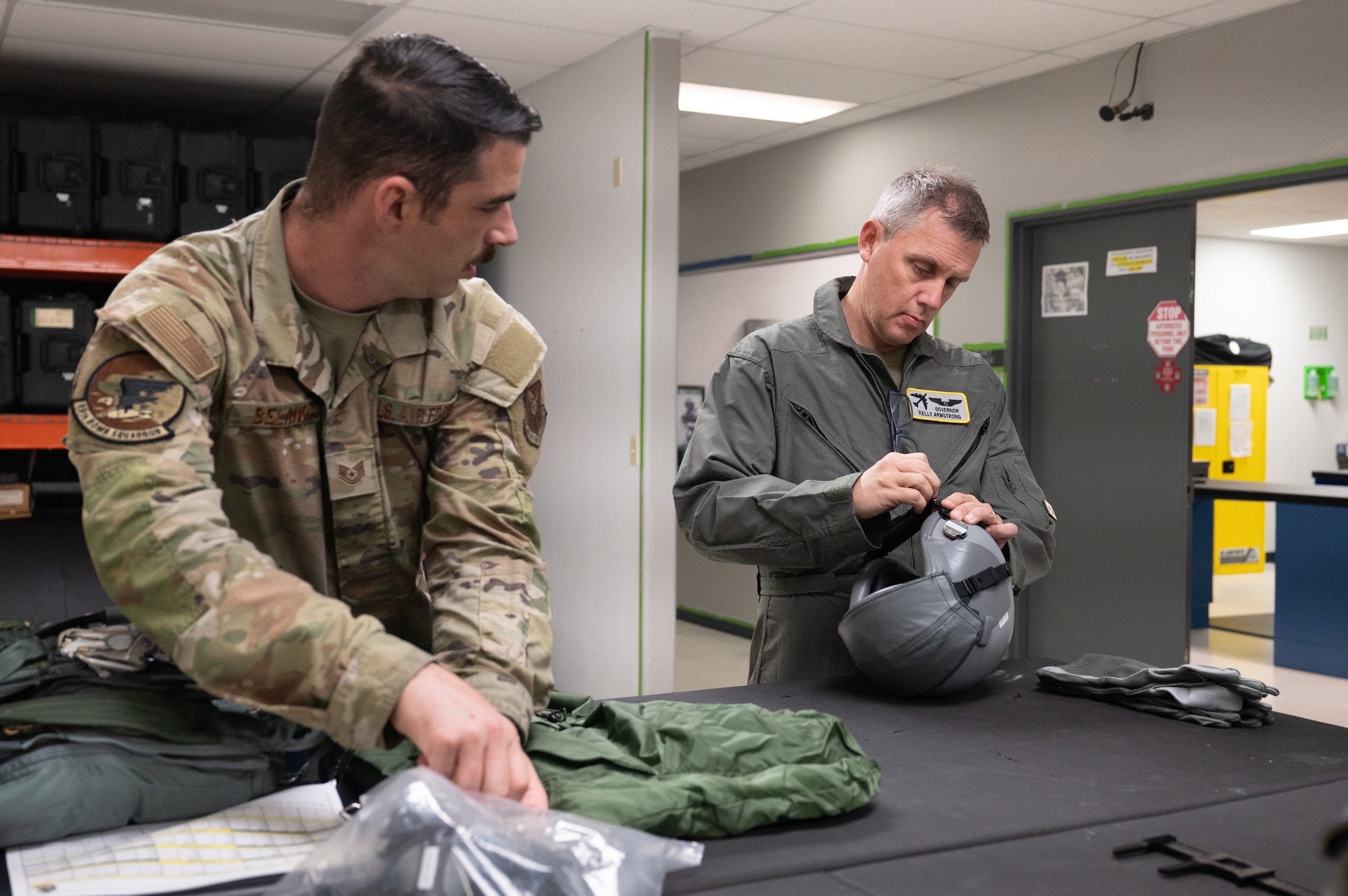 North Dakota Gov. Kelly Armstrong (right) adjusts his flight helmet before an orientation flight at Minot Air Force Base, North Dakota, June 30, 2025. Orientation flights are opportunities to educate key leaders on the 5th Bomb Wing’s mission capabilities. (U.S. Air Force photo by Senior Airman Kendra A. Ransum)