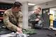 North Dakota Gov. Kelly Armstrong (right) adjusts his flight helmet before an orientation flight at Minot Air Force Base, North Dakota, June 30, 2025. Orientation flights are opportunities to educate key leaders on the 5th Bomb Wing’s mission capabilities. (U.S. Air Force photo by Senior Airman Kendra A. Ransum)